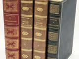 three books are stacked on top of each other on a white surface