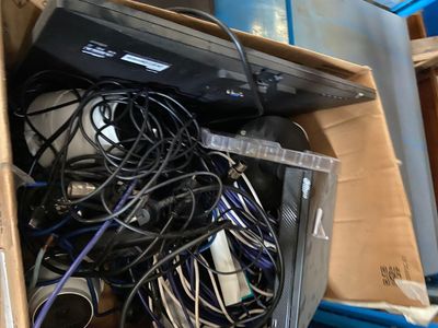 a box full of electronics and wires on the floor