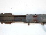 an old rusted metal object on a white surface