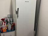 a white refrigerator in the corner of a room