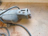 an image of a corded electric drill on the floor