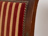 an image of a wooden chair with a red and yellow striped upholstered seat