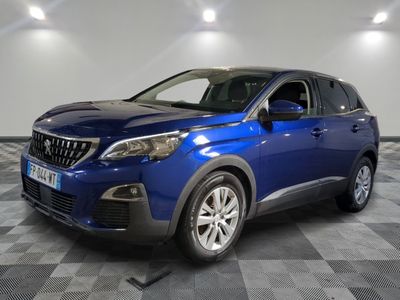 a blue car is parked in a room with a checkered floor