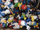 a lot of smurfs that are sitting in a box