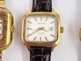 three different types of watches are displayed on a white surface