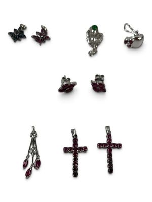 a lot of different types of jewelry on a white surface