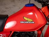 a close up of a red motorcycle with a honda logo on it