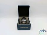 an image of a watch in a black box on a white surface