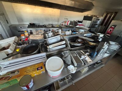 many pots and pans on the counter in the kitchen