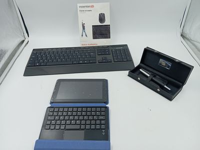 three laptops and a keyboard on a table