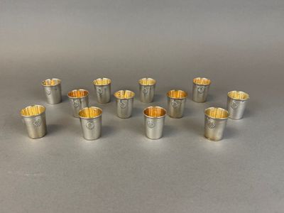 a set of six silverplated cups with gold rims