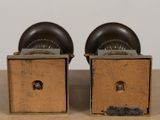two wooden boxes with black knobs on top of a table