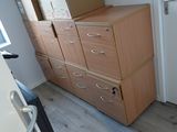 a tall wooden cabinet with drawers in a room