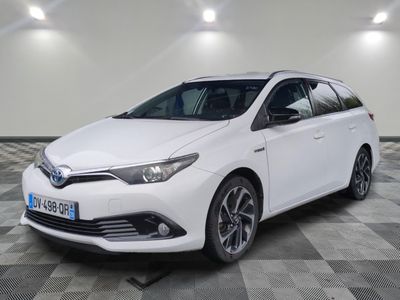 the toyota auris hybrid is parked on a checkered floor