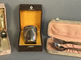 three silverware items sitting in a case on a table