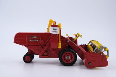 a toy tractor with a loader attached to the back of it