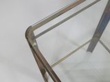 a glass table with a metal frame and a glass top