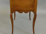 a small wooden table with a drawer on it