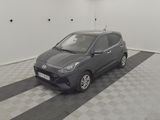 a picture of a small grey car in a garage