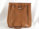 a tan leather handbag on a white background