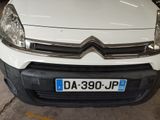 a white van parked in a parking lot next to other cars