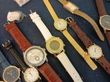 a lot of watches that are sitting on a table