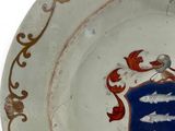 a white plate with a blue and red crest on it
