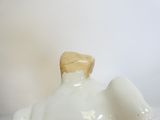 une petite figurine d'éléphant blanche posée sur une table