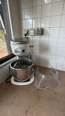 a kitchen with a mixer and a bowl on the counter