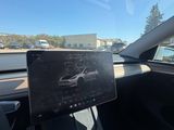 the interior of a car with a tablet on the dashboard