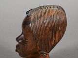 pair of carved wooden head sculptures of a woman and a man