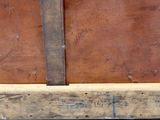a close up of a piece of wood with a knife on it