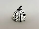 black and white polka dot pumpkin with a black cat on top