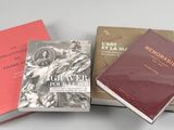 three books sitting on top of each other on top of a table