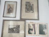 many framed pictures on the wall of a room