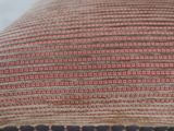 an image of a close up of a striped pillow on a bed