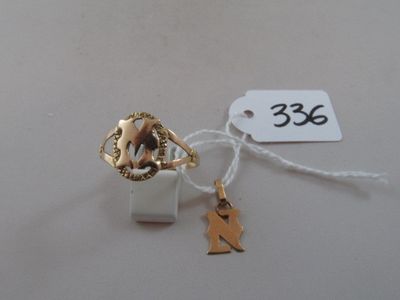 a small white box that has a gold charm on it
