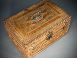 an old wooden box sitting on top of a gray surface