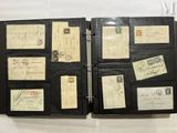 a black binder with a lot of old letters and stamps on it
