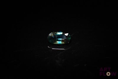 a close up of a ring on a table in the dark