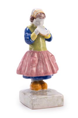 a figurine of a woman holding a piece of paper