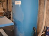 a large blue water tank with a hose attached to it
