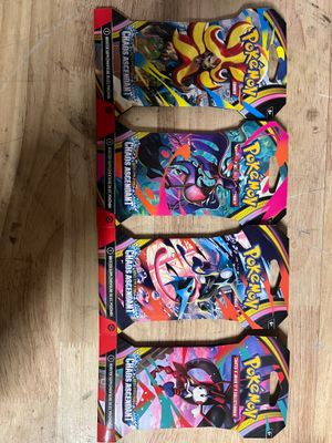 three pokemon trading cards on a wooden table with one of them in the foreground