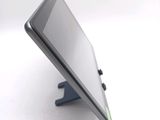 a close up of a cell phone that is on a stand