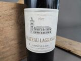 a bottle of wine sitting next to a wooden box