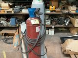 a red fire extinguisor sitting in a garage