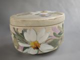 a small box with a flower painted on it