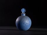 an image of a blue glass bottle on a black surface