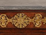 a close up of a wooden cabinet with a marble top