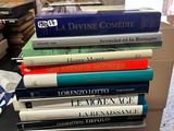 several books are stacked on top of each other on a table